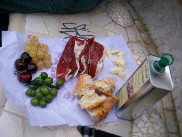 Picnic in Barcelona - bread, cheese, olives, grapes, jamon, olive oil.