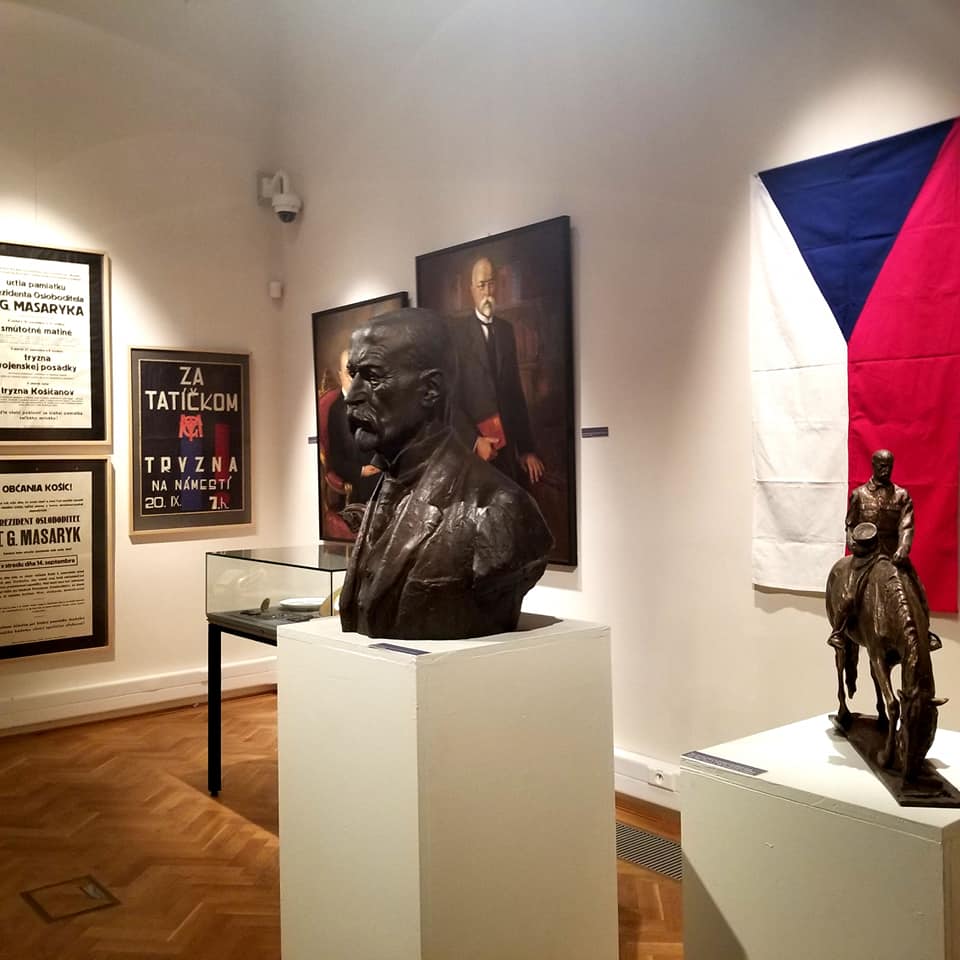 Czech flag in the background and a few statues in the foreground at the Eastern Slovak Museum. There is a bust of a former (unknown) general.