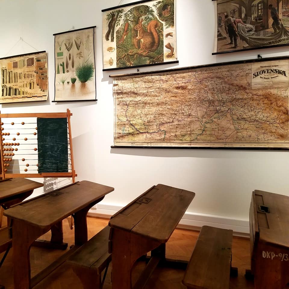 Replication of an Eastern Slovak School in the beginning of the 19th century. There are maps and charts adorning the walls, as well as long desks with built in pew-like benches.