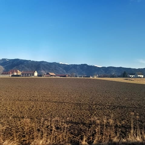 Fields, houses, and mountains - view from the overnight train from Rome to Vienna