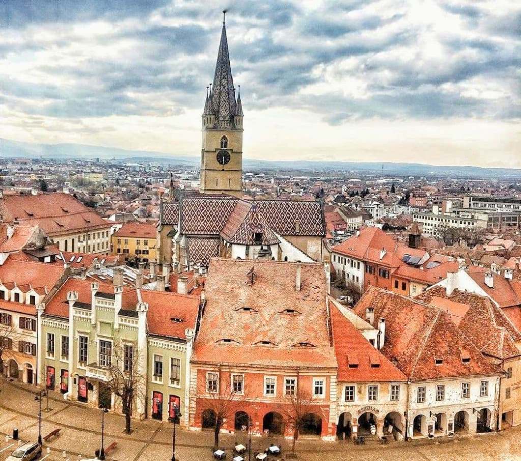 Things to do in Sibiu - Climb the council tower for this view of the red roofs and the Evangelical Church