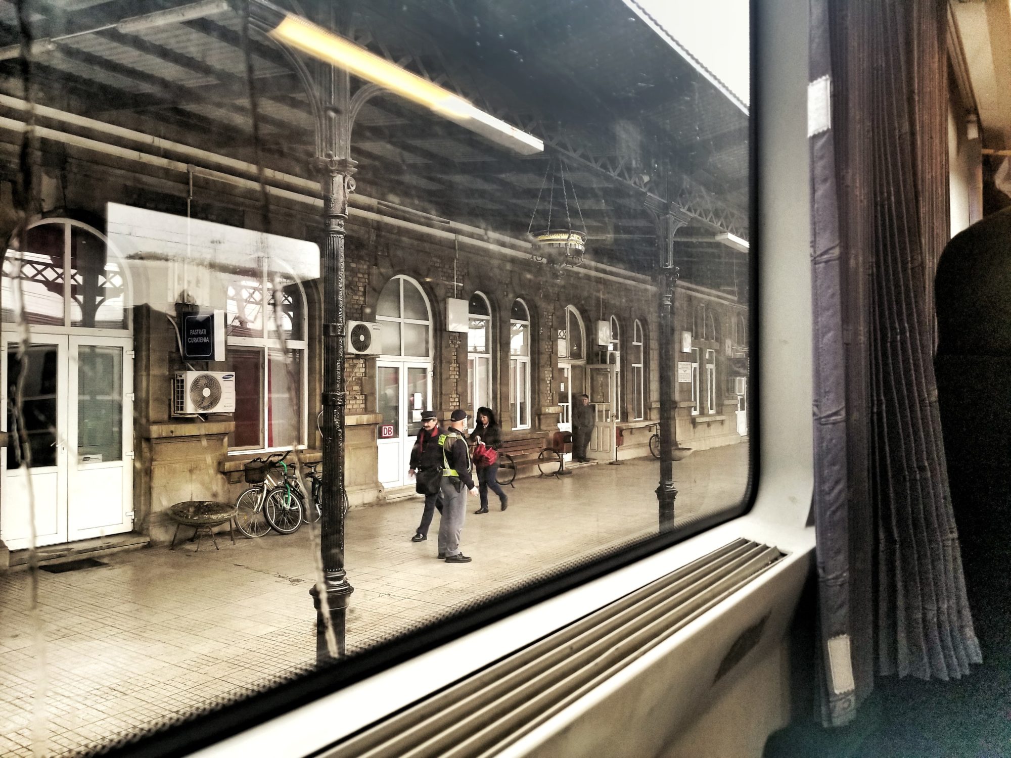 Looking out the train window to the Curtici train station and border control in Romania.