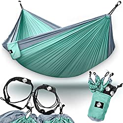 Pale turquoise travel hammock shown with carabiners and straps to set it up.  