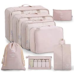 Set of four pale pink packing cubes, a laundry bag, toiletry case, and small bag.